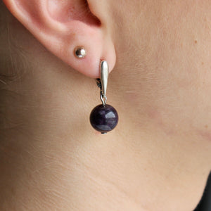 Amethyst orb earrings with silver clasps.