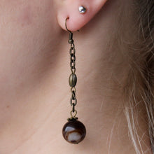 Load image into Gallery viewer, Brown Agate ball orb earrings that hang from intricate gold dangles.