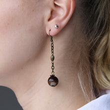 Load image into Gallery viewer, Brown Agate ball orb earrings that hang from intricate gold dangles.