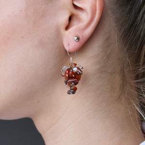 Carnelian earrings with red, orange, and brown stones and genuine silver hooks.