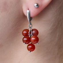 Load image into Gallery viewer, Carnelian earrings with brownish-red stones and silver hooks. 