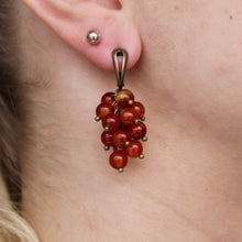 Load image into Gallery viewer, Collection of brown-red Carnelian stone orb dangle earrings with gold clasps.