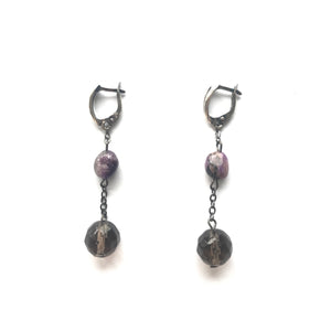 Purple Charoite and Topaz dangling earrings with silver clasps.