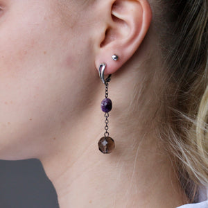 Purple Charoite and Topaz dangling earrings with silver clasps.