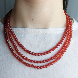 Orange-brown Carnelian triple layer orb necklace.