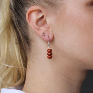 Three brownish-red Jasper stones on silver clasp dangle earrings.