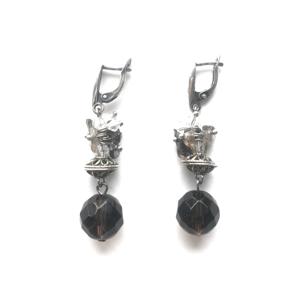 Purple Topaz orb dangling earrings with silver ornament and clasps.